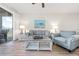 Bright living room with cozy furniture, neutral tones, and a balcony view offering a relaxing and inviting ambiance at 9630 Club South Cir # 6201, Sarasota, FL 34238