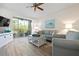 Inviting living room featuring wood floors, sliding glass doors to a balcony, and coastal-themed decor at 9630 Club South Cir # 6201, Sarasota, FL 34238