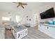 Cozy living room with a ceiling fan, light-colored walls, wood floors, and ample seating at 9630 Club South Cir # 6201, Sarasota, FL 34238