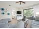Bright living room featuring stylish decor, wood floors, and a glimpse into a bedroom with a view of a relaxing balcony at 9630 Club South Cir # 6201, Sarasota, FL 34238