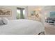 Comfortable main bedroom featuring a dresser, mirror, and sliding glass door to a balcony at 9630 Club South Cir # 6201, Sarasota, FL 34238