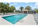 Beautiful pool with a screened cabana, lounge chairs, and tropical palm trees for relaxation at 9630 Club South Cir # 6201, Sarasota, FL 34238