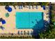 Aerial view of a refreshing community pool surrounded by lounge chairs and lush landscaping at 9630 Club South Cir # 6201, Sarasota, FL 34238