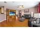Cozy living room with a large TV, wood-look floors and abundant natural light at 10615 Boyette Creek Blvd, Riverview, FL 33569