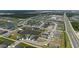 Aerial view showcases a residential community, featuring attractive landscaping, ponds, and single-Gathering homes at 11869 Richmond Trl, Parrish, FL 34219