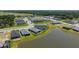 Aerial view of home featuring water view, and proximity to neighborhood streets and local amenities at 11869 Richmond Trl, Parrish, FL 34219
