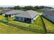 Backyard featuring a well-maintained lawn, a black fence, and an inviting outdoor seating area at 11869 Richmond Trl, Parrish, FL 34219