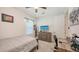 Bedroom features a wooden bed frame, a desk, a ceiling fan and great natural light at 11869 Richmond Trl, Parrish, FL 34219