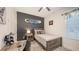Well-lit bedroom features a unique black accent wall and rustic wood furniture at 11869 Richmond Trl, Parrish, FL 34219