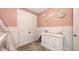 Pink bedroom featuring plush carpet, white wainscoting, and 'Sofia' wall decor at 11869 Richmond Trl, Parrish, FL 34219