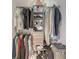 Well-organized closet with ample hanging space, shelving, and floor storage at 11869 Richmond Trl, Parrish, FL 34219
