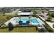 A resort style pool with plenty of seating, palm trees, and a clubhouse is a great amenity for the neighborhood at 11869 Richmond Trl, Parrish, FL 34219