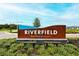 Beautifully landscaped community sign for Riverfield at North River Ranch in a welcoming neighborhood at 11869 Richmond Trl, Parrish, FL 34219
