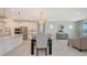 Open concept dining room with modern light fixture, view of kitchen with stainless appliances and bright windows at 11869 Richmond Trl, Parrish, FL 34219