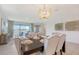Dining room area with modern chandelier lighting and neutral tones offers an open layout at 11869 Richmond Trl, Parrish, FL 34219