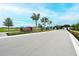 A long entryway to the community with palm trees, landscaping, and a large Riverfield North River Ranch sign at 11869 Richmond Trl, Parrish, FL 34219