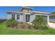 Charming one-story home featuring stone accents, a well-maintained lawn, and lush landscaping at 11869 Richmond Trl, Parrish, FL 34219
