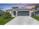 Charming single-story home with a two-car garage, landscaped lawn, and stone facade accents at 11869 Richmond Trl, Parrish, FL 34219