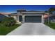 Charming single-story home with a two-car garage, landscaped lawn, and stone facade accents at 11869 Richmond Trl, Parrish, FL 34219