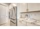 A close up view of the kitchen showcasing stainless steel appliances, quartz countertops, and white cabinetry at 11869 Richmond Trl, Parrish, FL 34219