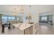 Modern kitchen with center island featuring quartz countertop, open to the dining area at 11869 Richmond Trl, Parrish, FL 34219