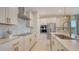 Modern kitchen showcasing stainless steel appliances, white cabinets, granite countertops, and sleek hardware at 11869 Richmond Trl, Parrish, FL 34219