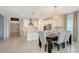 Bright and open kitchen features white cabinetry, stainless steel appliances, and overlooks the dining area at 11869 Richmond Trl, Parrish, FL 34219