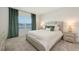 Serene main bedroom featuring a large window with a tranquil water view at 11869 Richmond Trl, Parrish, FL 34219