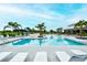 Large community pool with a sunbathing deck, shaded seating, and a clubhouse for residents' recreation at 11869 Richmond Trl, Parrish, FL 34219