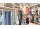 Well-organized walk-in closet with hanging rods, shelves, and ample storage for clothing and accessories at 11869 Richmond Trl, Parrish, FL 34219