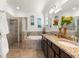 Bathroom featuring double sinks, a soaking tub, and separate walk-in shower at 12501 Cinqueterre Dr, Venice, FL 34293