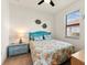 Cozy bedroom features a full-size bed, side table and colorful coastal decor at 12501 Cinqueterre Dr, Venice, FL 34293