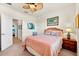 Inviting bedroom featuring carpet, a ceiling fan, and an en-suite bathroom at 12501 Cinqueterre Dr, Venice, FL 34293