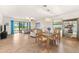 Bright dining area features a glass table, seating for six, and sliding glass doors to a screened lanai at 12501 Cinqueterre Dr, Venice, FL 34293