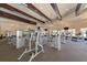 Spacious gym with high ceilings, wooden beams, ceiling fans, carpeted floor and lots of exercise equipment at 12501 Cinqueterre Dr, Venice, FL 34293
