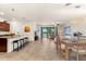 Open concept living space featuring a kitchen island, dining area, and comfortable living area with outdoor views at 12501 Cinqueterre Dr, Venice, FL 34293