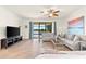 Comfortable living room featuring tile floors, a ceiling fan, and peaceful views at 12501 Cinqueterre Dr, Venice, FL 34293