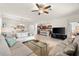 Spacious living room featuring an open floor plan, tile flooring, and views into the kitchen at 12501 Cinqueterre Dr, Venice, FL 34293
