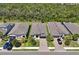 New home with well-manicured lawn, paver driveway, and lush trees lining the property at 14514 20Th E St, Parrish, FL 34219