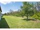 Large backyard with well-maintained grass and beautiful trees, ideal for outdoor activities at 14514 20Th E St, Parrish, FL 34219
