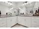 Spacious bathroom with dual vanities, granite countertops, large mirrors, and ample storage space at 14514 20Th E St, Parrish, FL 34219