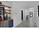 Bright hallway with tiled floors and views into other rooms, including a bar area with a wine fridge at 14514 20Th E St, Parrish, FL 34219