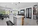 Bright kitchen with modern island, stainless steel appliances, and open layout to dining and living areas at 14514 20Th E St, Parrish, FL 34219