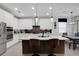 Bright kitchen features white cabinets, stainless steel appliances, island with seating and decorative brown backsplash at 14514 20Th E St, Parrish, FL 34219