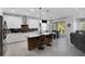 Modern kitchen with white cabinetry, a central island, and stainless steel appliances, open to the living area at 14514 20Th E St, Parrish, FL 34219