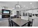 Open-concept living and dining room featuring kitchen with modern appliances, pendant lighting, and breakfast bar at 14514 20Th E St, Parrish, FL 34219