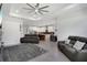 Open-concept living room with modern furnishings, recessed lighting, and seamless flow to kitchen at 14514 20Th E St, Parrish, FL 34219