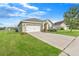 Well-maintained single-Gathering home with a two-car garage, manicured lawn, and inviting curb appeal at 14914 Flowing Gold Dr, Bradenton, FL 34212