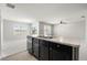 Open-concept kitchen with a central island, dark cabinetry, and views into the living area at 14914 Flowing Gold Dr, Bradenton, FL 34212