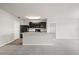 Kitchen featuring a large island with views of the living area, dark cabinets, and modern appliances at 14914 Flowing Gold Dr, Bradenton, FL 34212